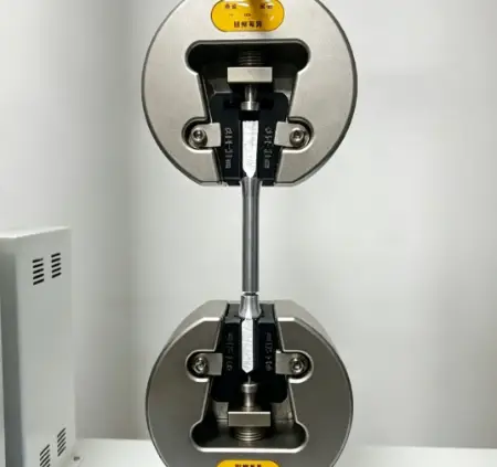Hydraulic universal testing machine performing tensile testing on a steel rebar specimen